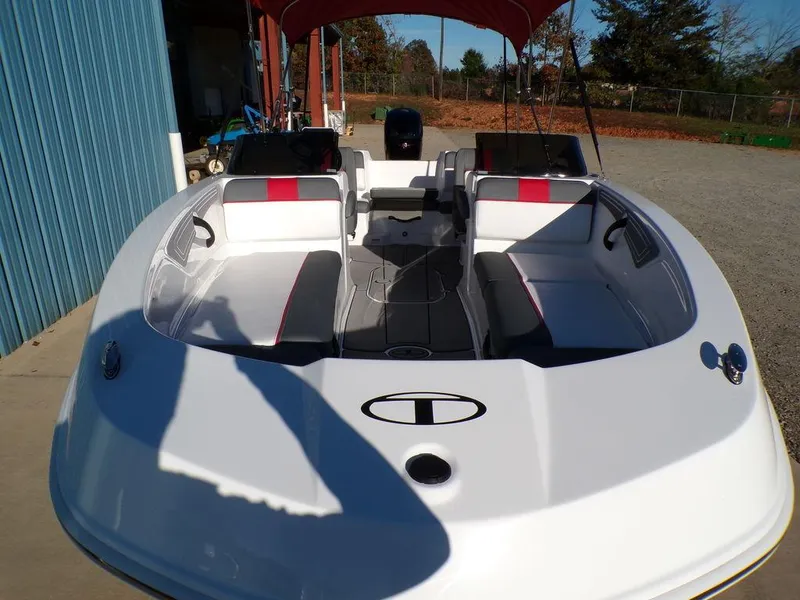 Slide: The Image of 2025 Tahoe T21 boat with white and red seating, docked outdoors. - 28