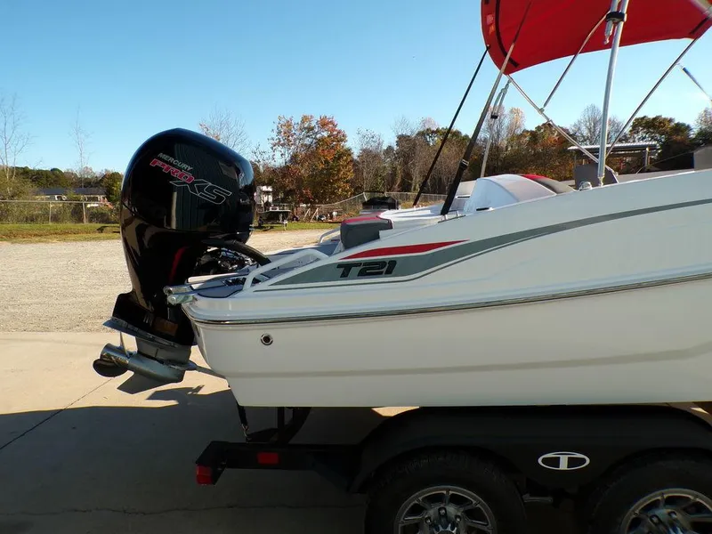 Slide: The Image of 2025 Tahoe T21 boat with outboard motor on trailer, red canopy, outdoor setting. - 5