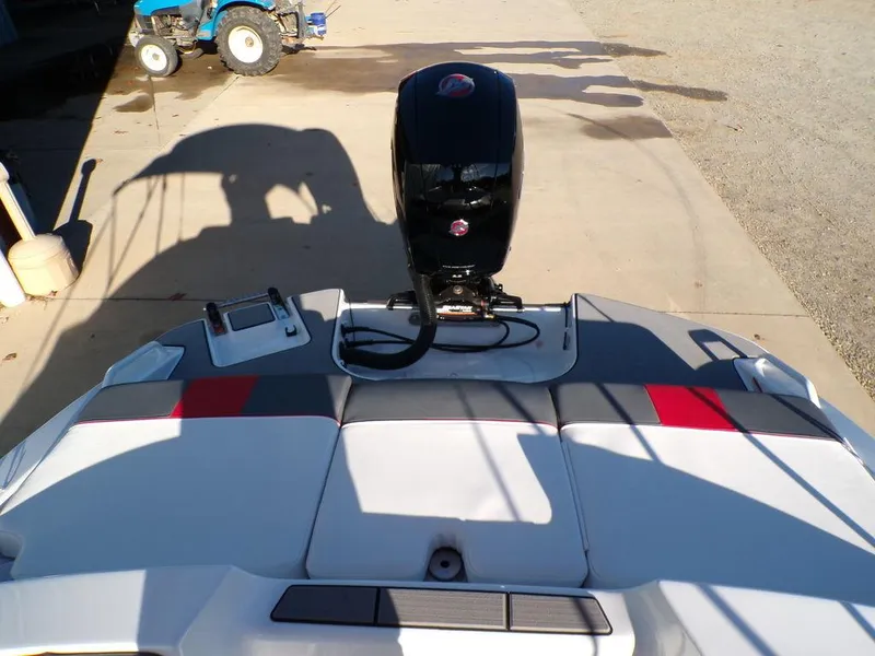 Slide: The Image of 2025 Tahoe T21 boat with outboard motor, parked on concrete surface. - 8