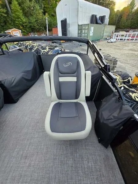 Slide: The Image of 2022 Barletta C20QC boat seat with gray upholstery, outdoor setting. - 1