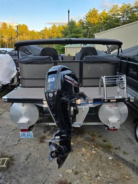 Slide: The Image of 2022 Barletta C20QC pontoon boat with Mercury 60 outboard motor, parked outdoors. - 10