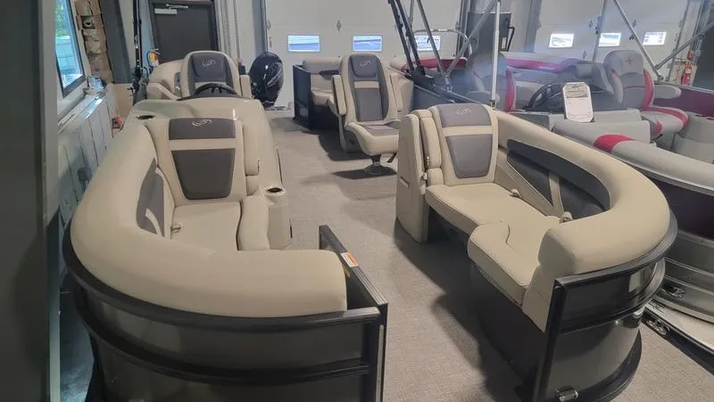 Slide: The Image of 2022 Barletta C20QC pontoon boat interior with plush seating in showroom. - 2