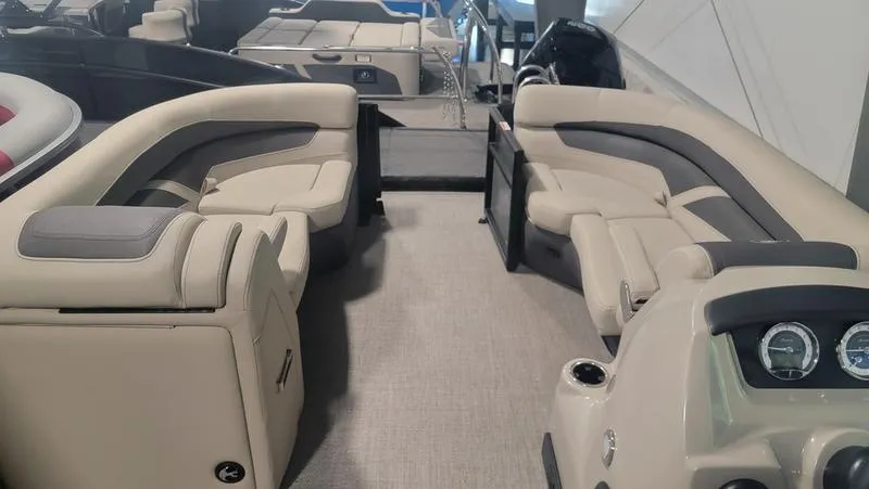 Slide: The Image of 2022 Barletta C20QC pontoon boat interior with beige seating and modern dashboard. - 4