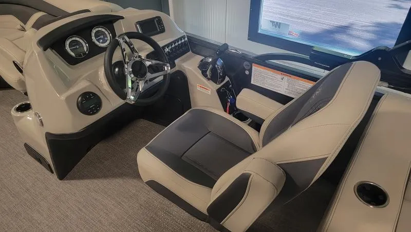 Slide: The Image of 2022 Barletta C20QC boat interior with steering wheel and captain's chair. - 5