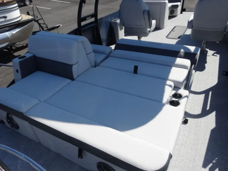 Slide: The Image of 2025 Harris SUNLINER SP 250 boat interior with spacious seating and cup holders. - 13