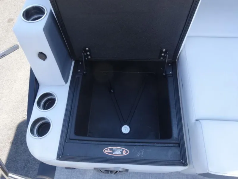 Slide: The Image of Open storage compartment on 2025 Harris SUNLINER SP 250 boat with cup holders. - 14