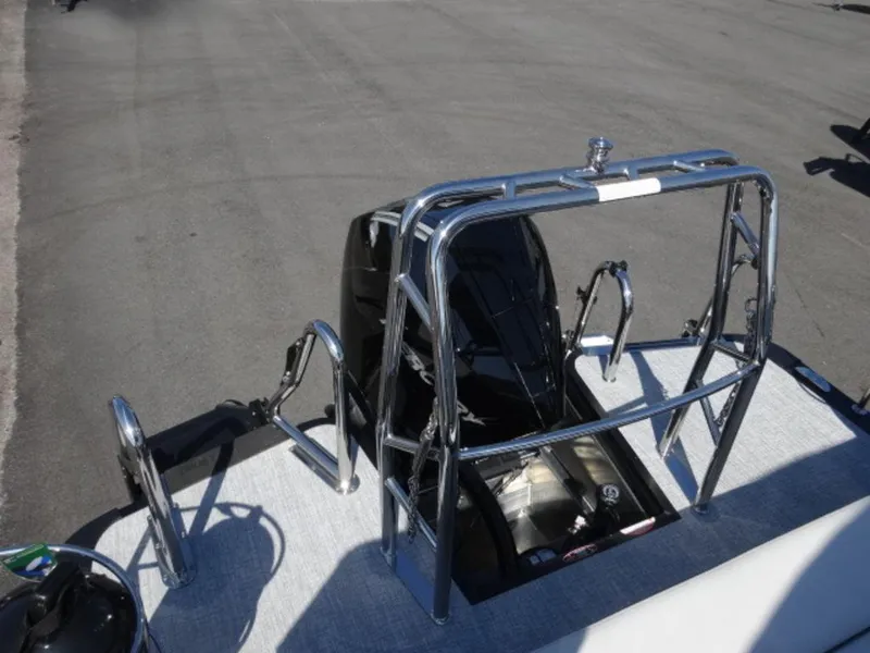 Slide: The Image of 2025 Harris SUNLINER SP 250 boat with chrome railing and engine view. - 16
