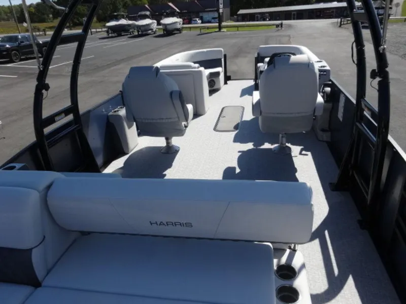 Slide: The Image of 2025 Harris SUNLINER SP 250 boat interior with seating and steering console. - 17