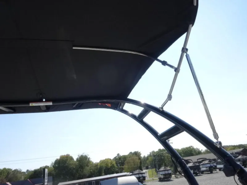 Slide: The Image of 2025 Harris SUNLINER SP 250 boat canopy and support structure under clear sky. - 18