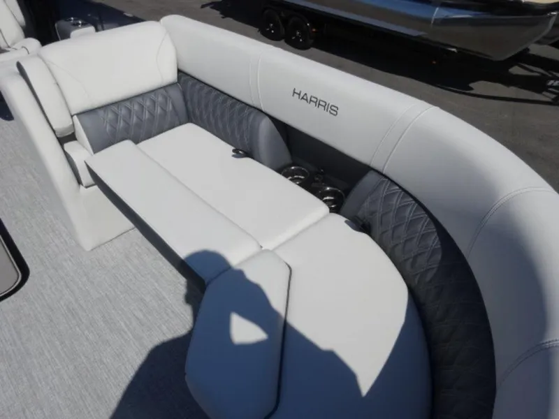 Slide: The Image of 2025 Harris SUNLINER SP 250 boat interior with luxurious white seating and cup holders. - 4