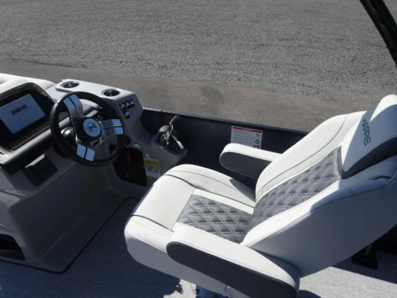 Slide: The Image of 2025 Harris SUNLINER SP 250 boat interior with steering wheel and cushioned seat. - 8
