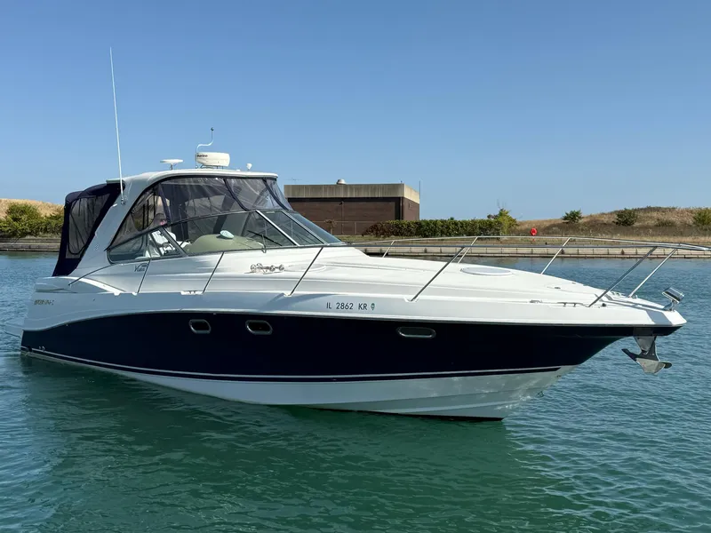 Slide: The Image of 2005 Four Winns 378 Vista yacht on calm water under clear blue sky. - 0