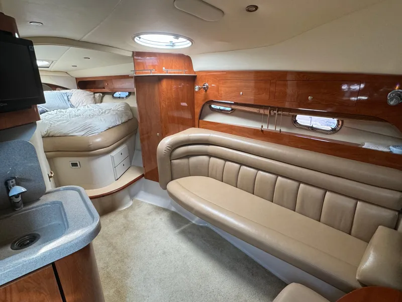 Slide: The Image of Interior of 2005 Four Winns 378 Vista yacht with plush seating and cozy sleeping area. - 10
