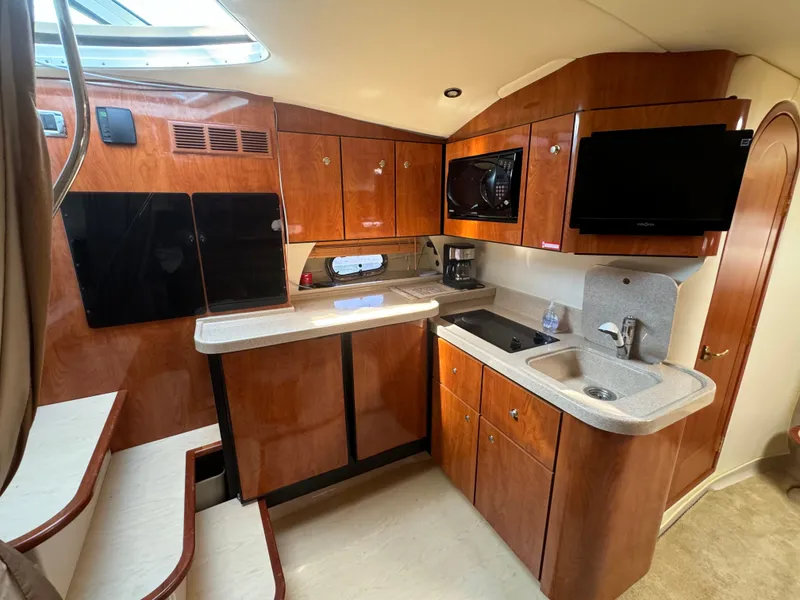 Slide: The Image of 2005 Four Winns 378 Vista yacht interior kitchen with wood cabinets and modern appliances. - 12