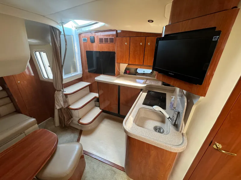 Slide: The Image of Interior of 2005 Four Winns 378 Vista yacht with kitchenette and seating area. - 13