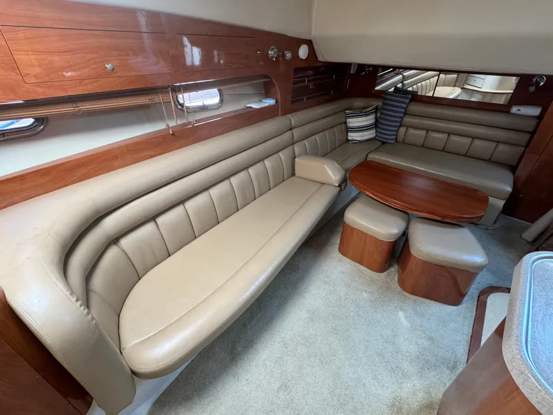 Slide: The Image of 2005 Four Winns 378 Vista yacht interior with beige leather seating and wooden table. - 15