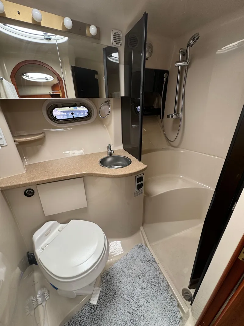Slide: The Image of 2005 Four Winns 378 Vista boat bathroom with shower, sink, and toilet. - 19