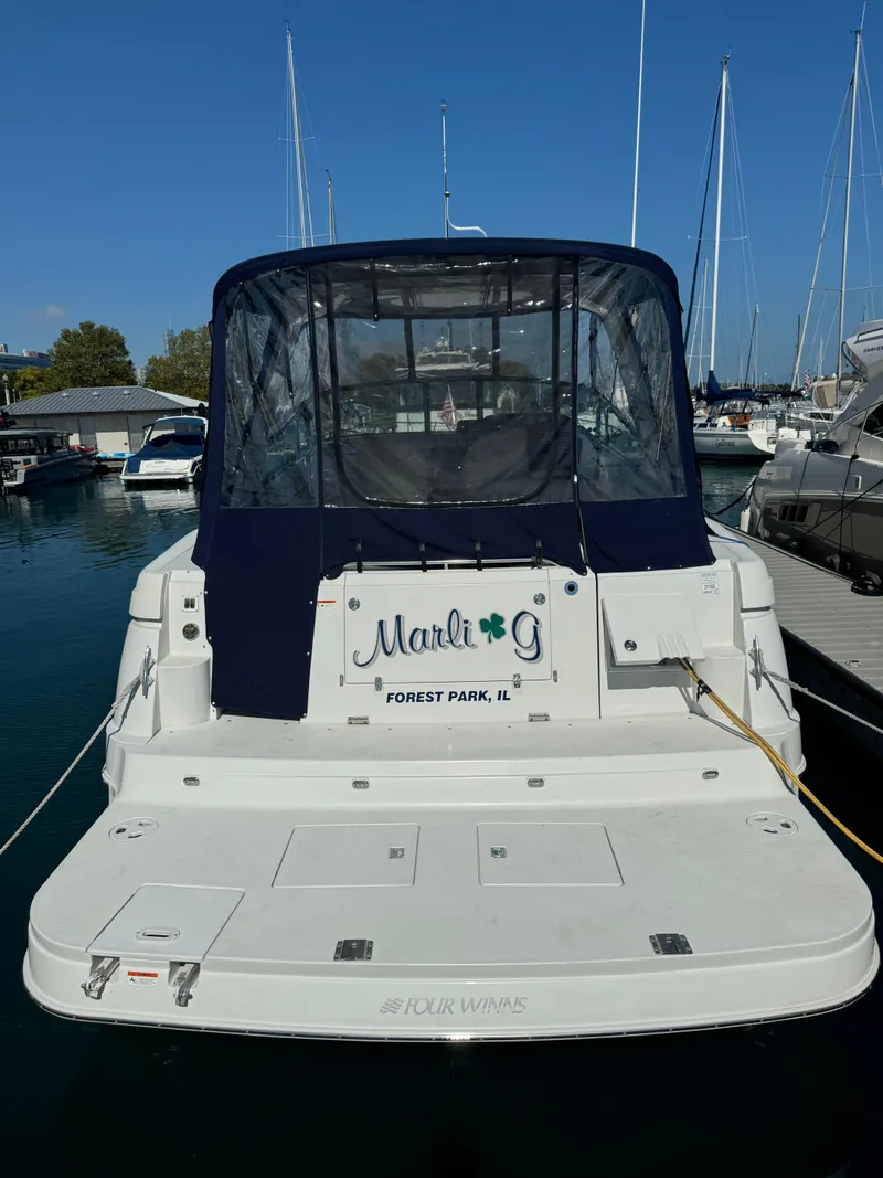 Slide: The Image of 2005 Four Winns 378 Vista boat docked in marina, rear view. - 3