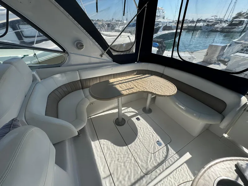 Slide: The Image of 2005 Four Winns 378 Vista yacht interior with seating and table, docked at marina. - 4