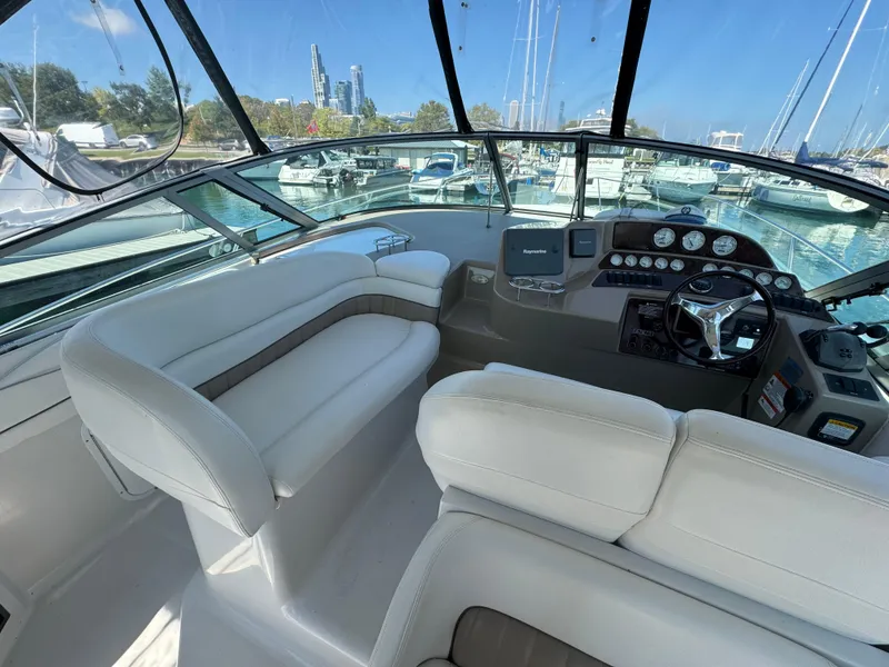 Slide: The Image of 2005 Four Winns 378 Vista yacht cockpit with white seating and control panel. - 6