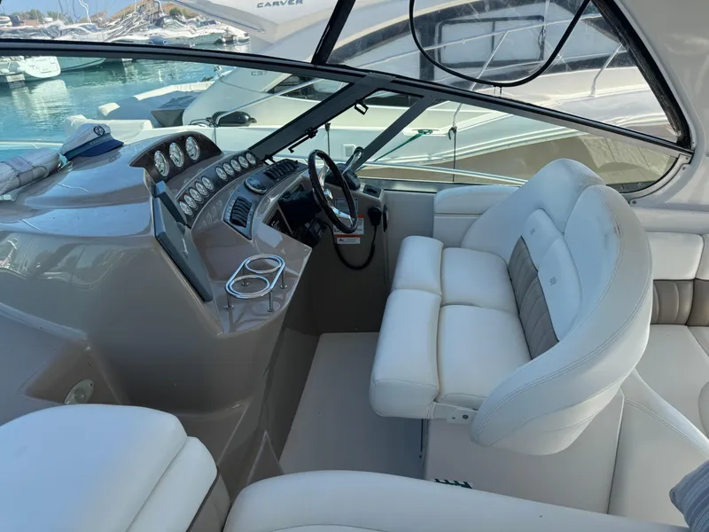 Slide: The Image of 2005 Four Winns 378 Vista boat interior with white seating and control panel. - 7