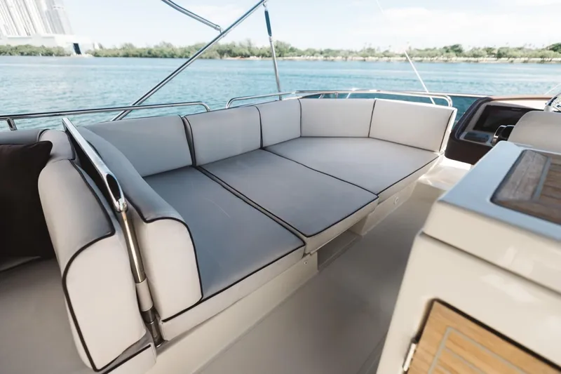Slide: The Image of Luxurious seating on 2015 Beneteau Monte Carlo 5 yacht, overlooking serene waters. - 10