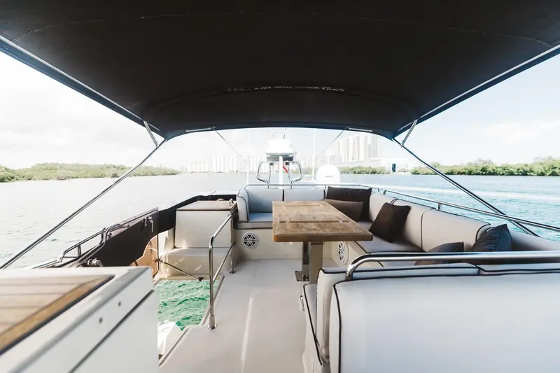 Slide: The Image of 2015 Beneteau Monte Carlo 5 yacht interior with seating and table on deck. - 12