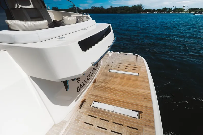 Slide: The Image of 2015 Beneteau Monte Carlo 5 yacht with teak swim platform on calm water. - 17