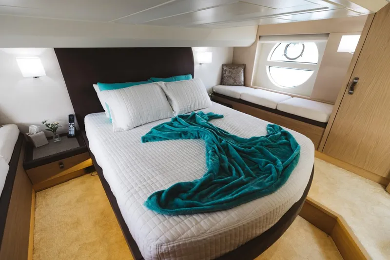 Slide: The Image of Luxurious bedroom in 2015 Beneteau Monte Carlo 5 yacht with elegant decor and natural light. - 24