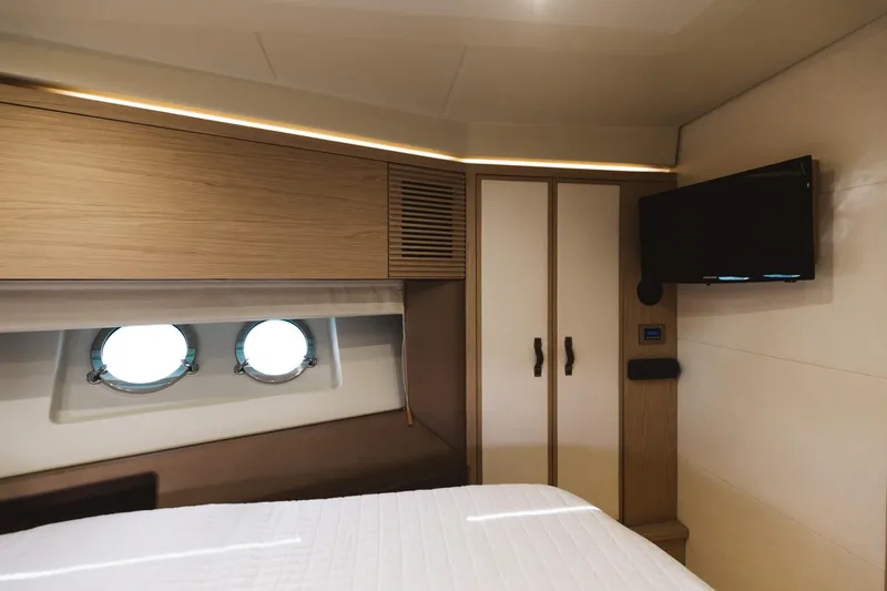 Slide: The Image of Luxurious cabin interior of 2015 Beneteau Monte Carlo 5 yacht with portholes and TV. - 27