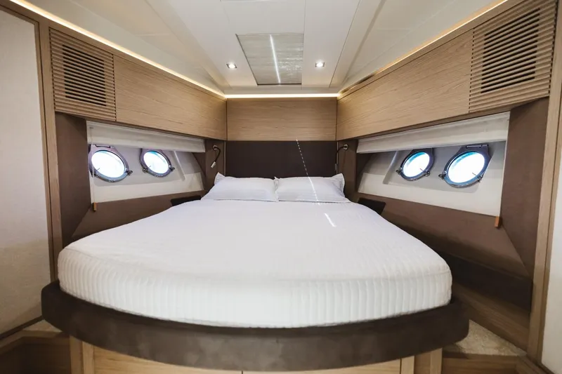 Slide: The Image of Luxurious bedroom interior of 2015 Beneteau Monte Carlo 5 yacht with round windows. - 28