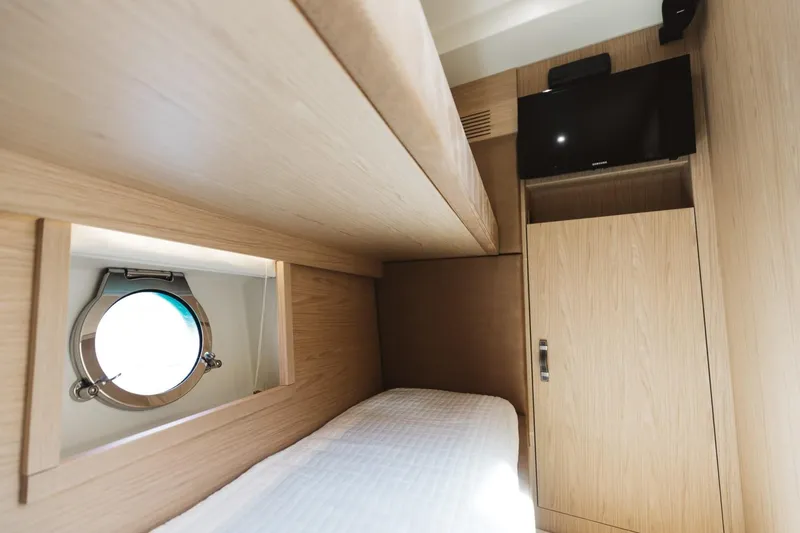 Slide: The Image of Interior cabin of 2015 Beneteau Monte Carlo 5 yacht with porthole and TV. - 29