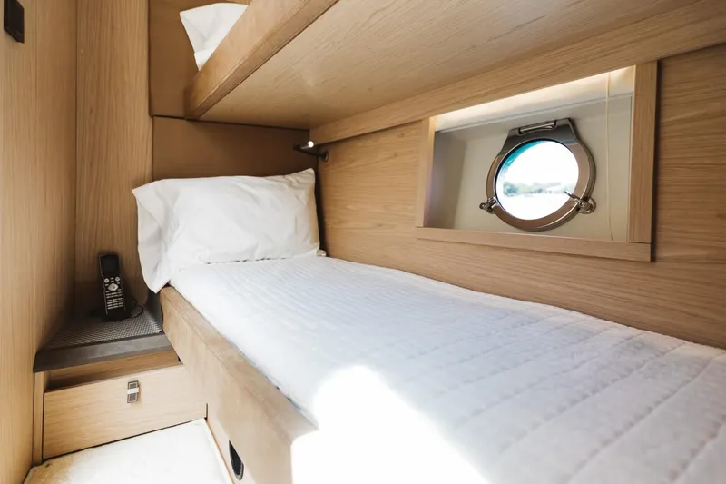 Slide: The Image of Cozy cabin interior of 2015 Beneteau Monte Carlo 5 yacht with porthole and single bed. - 31