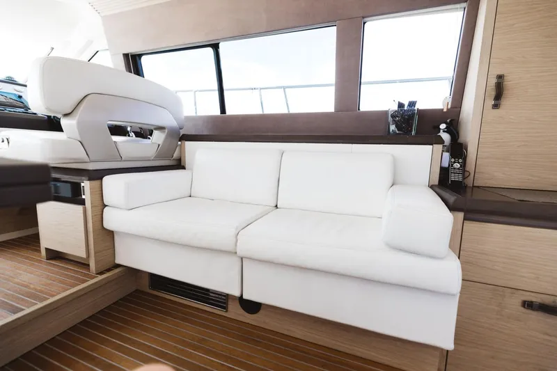 Slide: The Image of Luxurious interior of 2015 Beneteau Monte Carlo 5 yacht with white sofa and wooden flooring. - 39