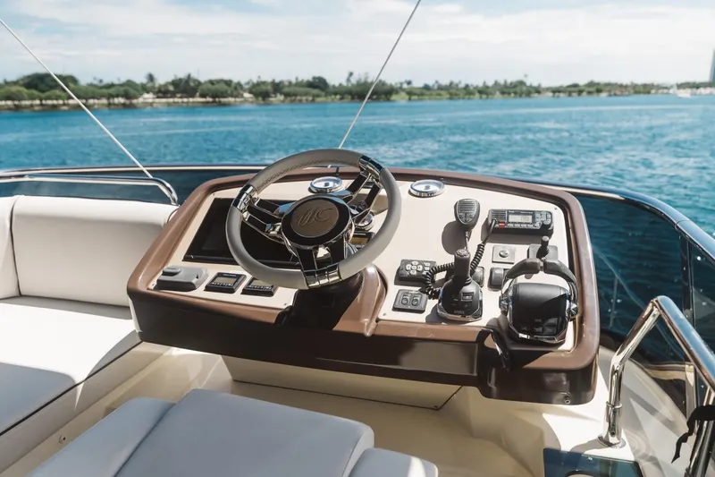 Slide: The Image of Beneteau Monte Carlo 5 yacht helm, 2015 model, overlooking serene blue waters. - 6