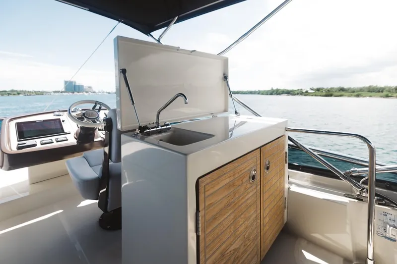Slide: The Image of Beneteau Monte Carlo 5 yacht kitchen area with sink, 2015 model, overlooking water. - 7