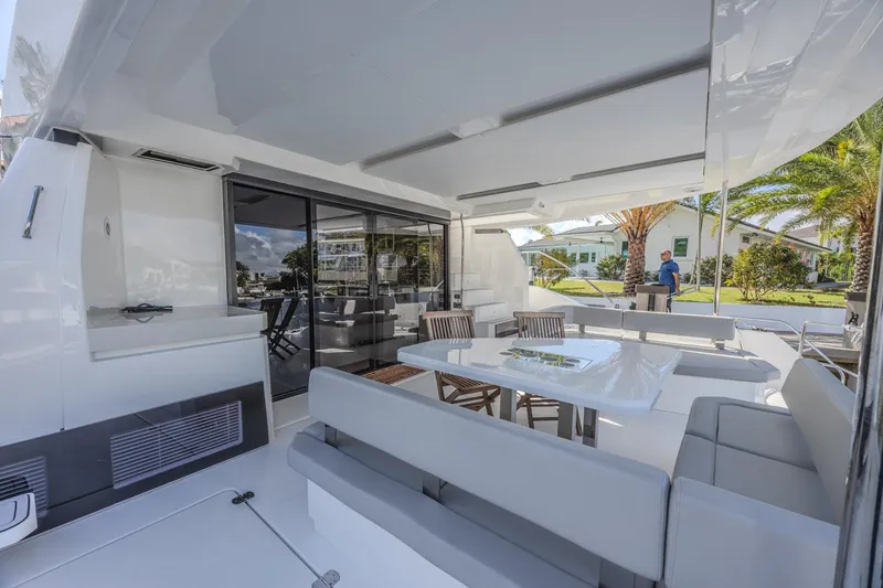 Slide: The Image of 2024 Leopard 53 Powercat yacht interior with modern seating and dining area. - 12