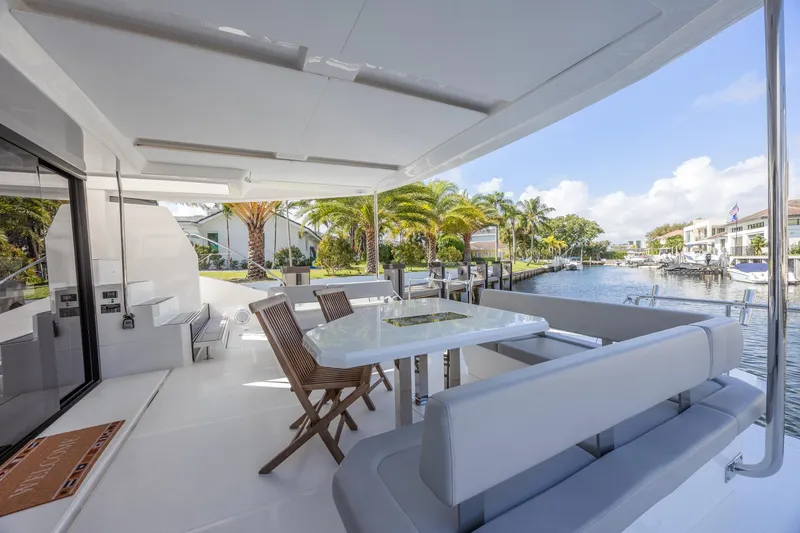 Slide: The Image of 2024 Leopard 53 Powercat yacht deck with seating and waterfront view. - 13