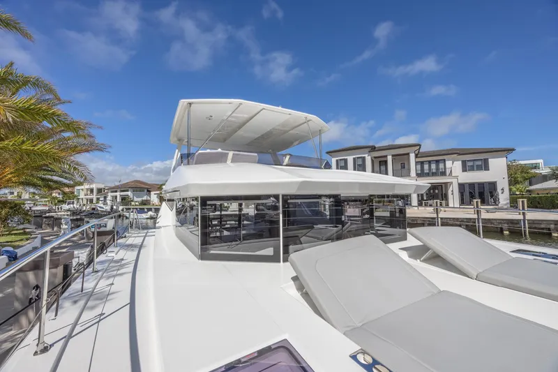 Slide: The Image of 2024 Leopard 53 Powercat yacht docked, featuring sleek design and spacious deck. - 18