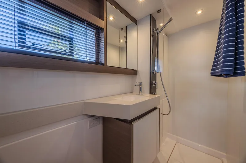 Slide: The Image of Modern bathroom in 2024 Leopard 53 Powercat yacht with sleek fixtures and striped towel. - 29