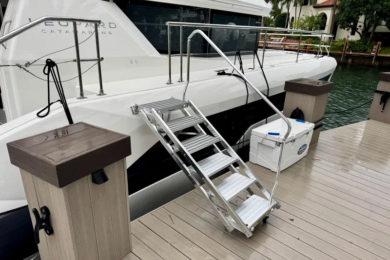 Slide: The Image of 2024 Leopard 53 Powercat docked with boarding ladder and cooler on deck. - 4