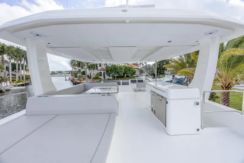 Slide: The Image of 2024 Leopard 53 Powercat yacht deck with modern seating and outdoor kitchen. - 7
