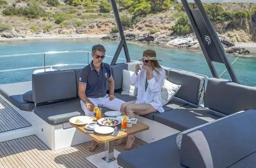 Slide: The Image of Couple enjoying breakfast on 2025 Fountaine Pajot Power 67 yacht, scenic coastal backdrop. - 10