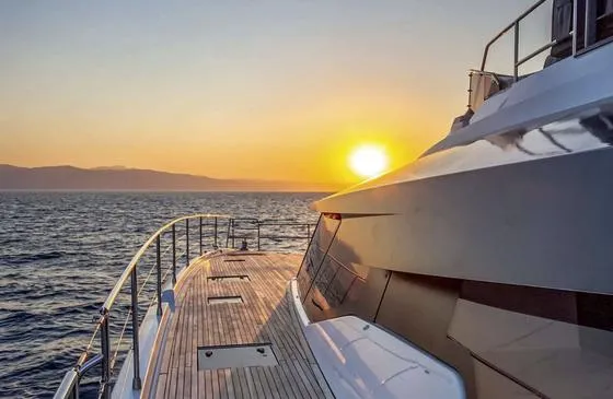 Slide: The Image of 2025 Fountaine Pajot Power 67 yacht at sunset on the open sea. - 17