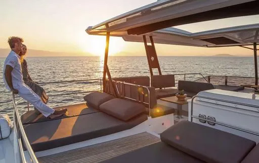 Slide: The Image of 2025 Fountaine Pajot Power 67 yacht at sunset, featuring spacious deck and luxurious seating. - 18