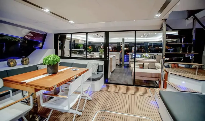 Slide: The Image of Luxurious interior of 2025 Fountaine Pajot Power 67 yacht with elegant dining area. - 20