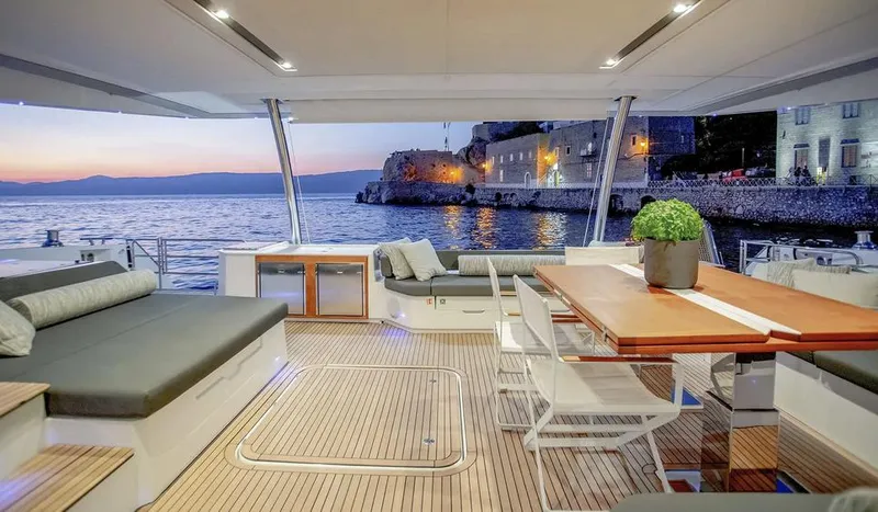 Slide: The Image of Luxurious 2025 Fountaine Pajot Power 67 yacht interior with ocean view at sunset. - 21