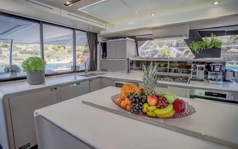 Slide: The Image of Luxurious kitchen interior of 2025 Fountaine Pajot Power 67 yacht with fruit centerpiece. - 23