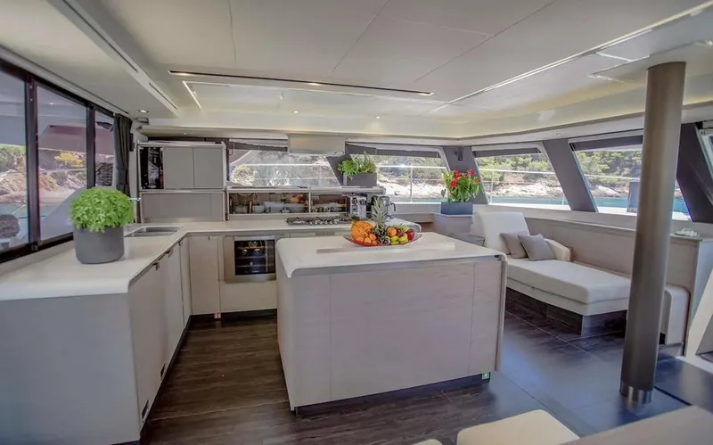 Slide: The Image of Luxurious interior of 2025 Fountaine Pajot Power 67 yacht with modern kitchen and seating area. - 24