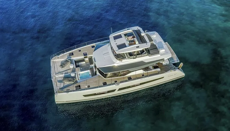 Slide: The Image of 2025 Fountaine Pajot Power 67 yacht on clear blue water, aerial view. - 35